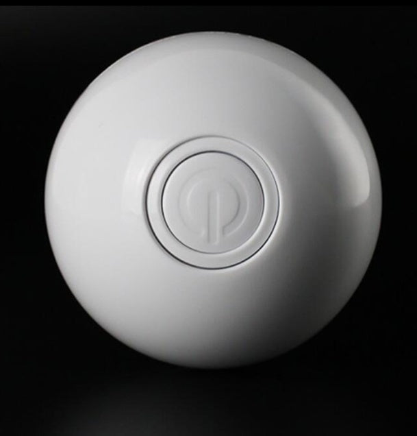 White smart cat toy ball showing embossed power symbol.