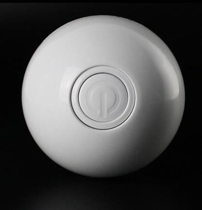 White smart cat toy ball showing embossed power symbol.