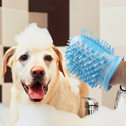 Close view of blue bristle paw cleaner used during dog bath with foam.