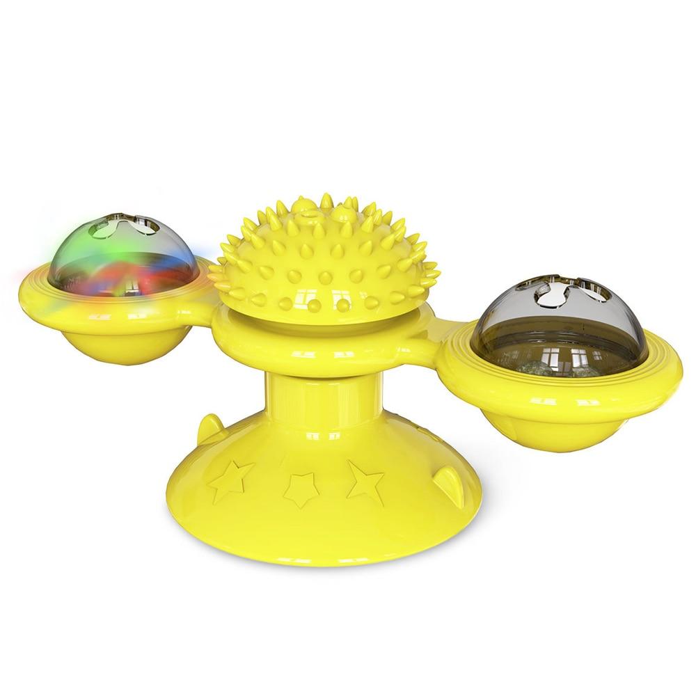 Close-up of yellow spinning cat toy with two clear LED pods and textured central hub