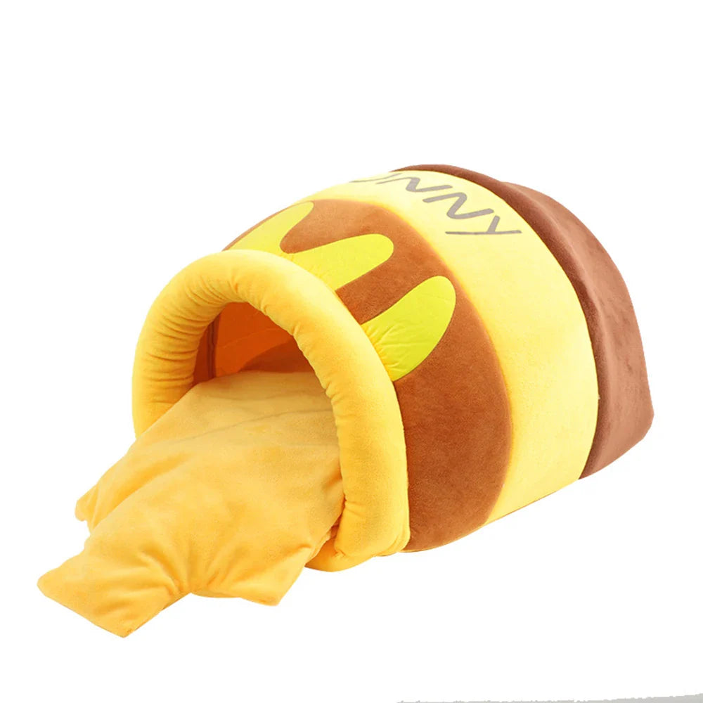 Angled view of honey jar cat tunnel with extended yellow blanket mat.